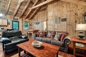 A log cabin interior with a pool table, leather sofas, and a wooden dining table. - Pool Table Hottub Gburg & Pigeon Forge 8 miles (Sevierville)