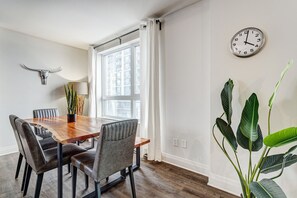 Elegant dining area with large windows in Laval, Quebec - Urban 2BR Escape In-suite Laundry and Terrace (Laval)