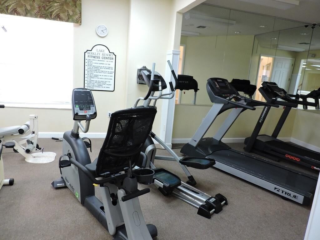 A fitness center with cardio equipment including an elliptical, stationary bikes, and treadmills.