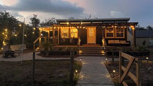 A house with a covered porch, a front door, and a pathway leading to the entrance. - Lake Side Tiny home in Punta Gorda, Florida (Punta Gorda)