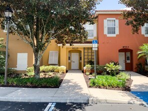 A two-story building with a yellow facade, numbered 8523. - Luxury Lake View 3 bedroom in resort community. Disney 3 miles (Kissimmee)