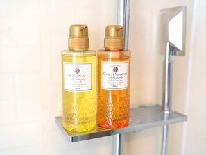 Two bottles of body soap and rinse in shampoo on a bathroom shelf. - T-PARK Airport Side 1 (Miyakojima)