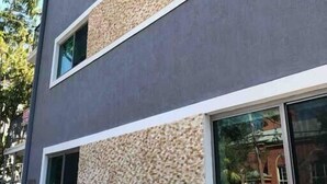 A modern building with a grey facade and textured stone accents. - THE GROVE 6    10 MIN FROM THE BEACH In the heart of Coconut Grove and CocoWalk (Miami)