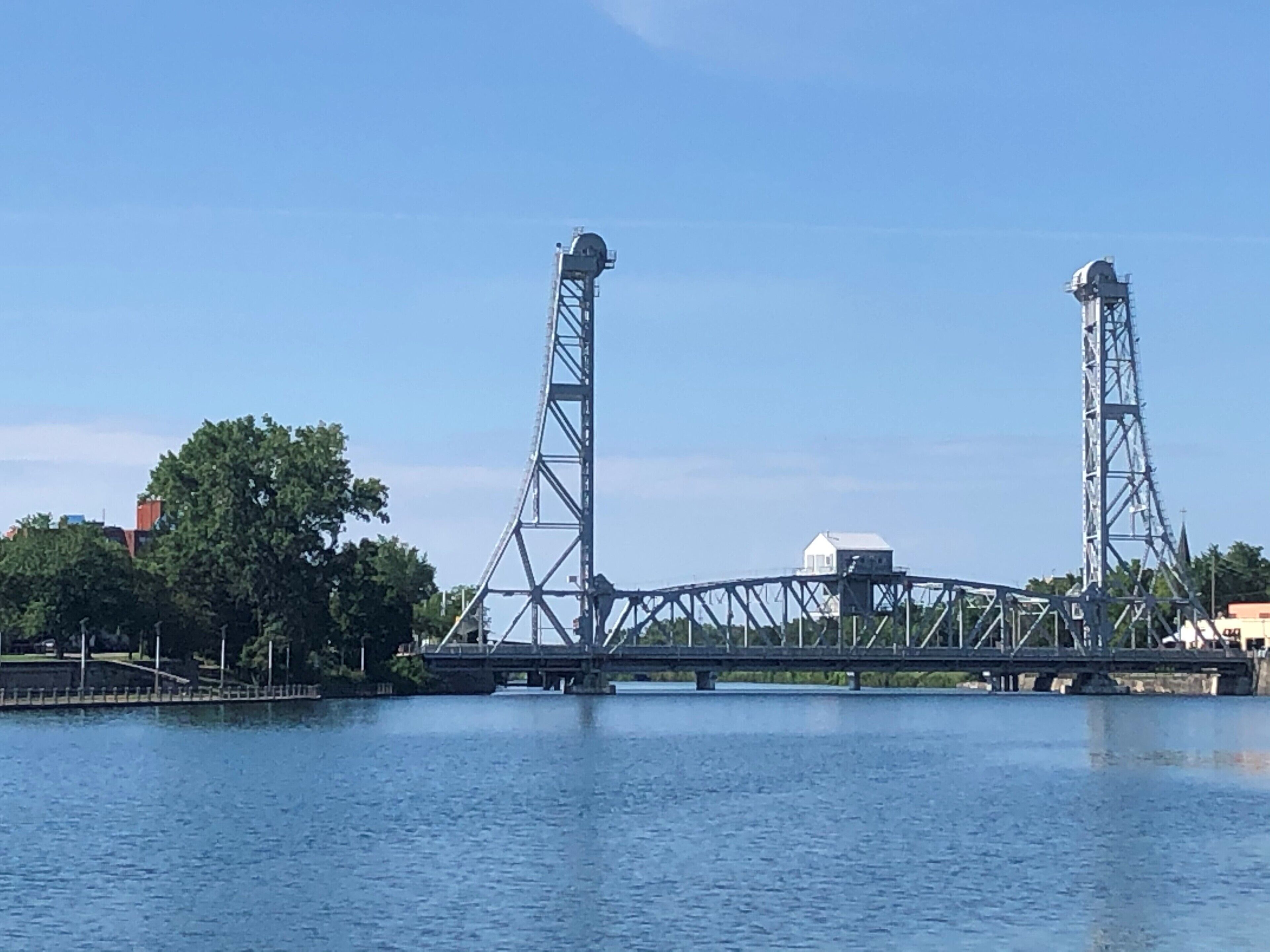 A bridge with two towers over a body of water.