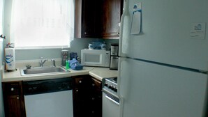 A kitchen with a dishwasher, microwave, oven, and refrigerator. - Sugar Ski & Country Club Unit 11-803 Silver (Banner Elk)