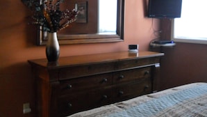 A bedroom with a bed, dresser, mirror, and television. - Sugar Ski & Country Club Unit 413 Silver (Banner Elk)