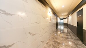 A hallway with marble walls and a polished floor, leading to a door labeled "Furnace." - The Way Hotel (Changwon)