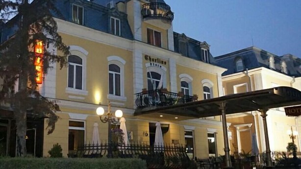A hotel with a classic European architectural style, featuring a prominent balcony and a sign that reads "Hotel". - Charlino Plaza (Ruse)
