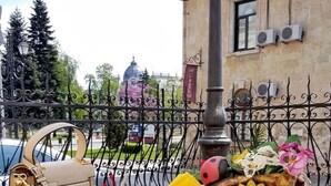 A table set with white teacups, a teapot, a teacandle, a yellow napkin, and a handbag. - Charlino Plaza (Ruse)