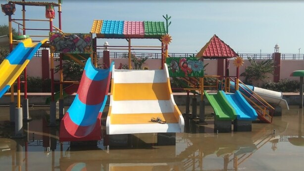 A water park with multiple slides and play structures. - Rawat Resorts (Tivari)