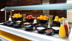 A buffet with various fruits, bowls of food, and beverages. - Hotel Sfax Palace by Plaza Hotels & Resorts (Sfax)