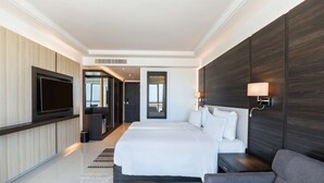 A modern hotel room with a large bed, a TV, a sofa, and a desk. - Hotel Sfax Palace by Plaza Hotels & Resorts (Sfax)