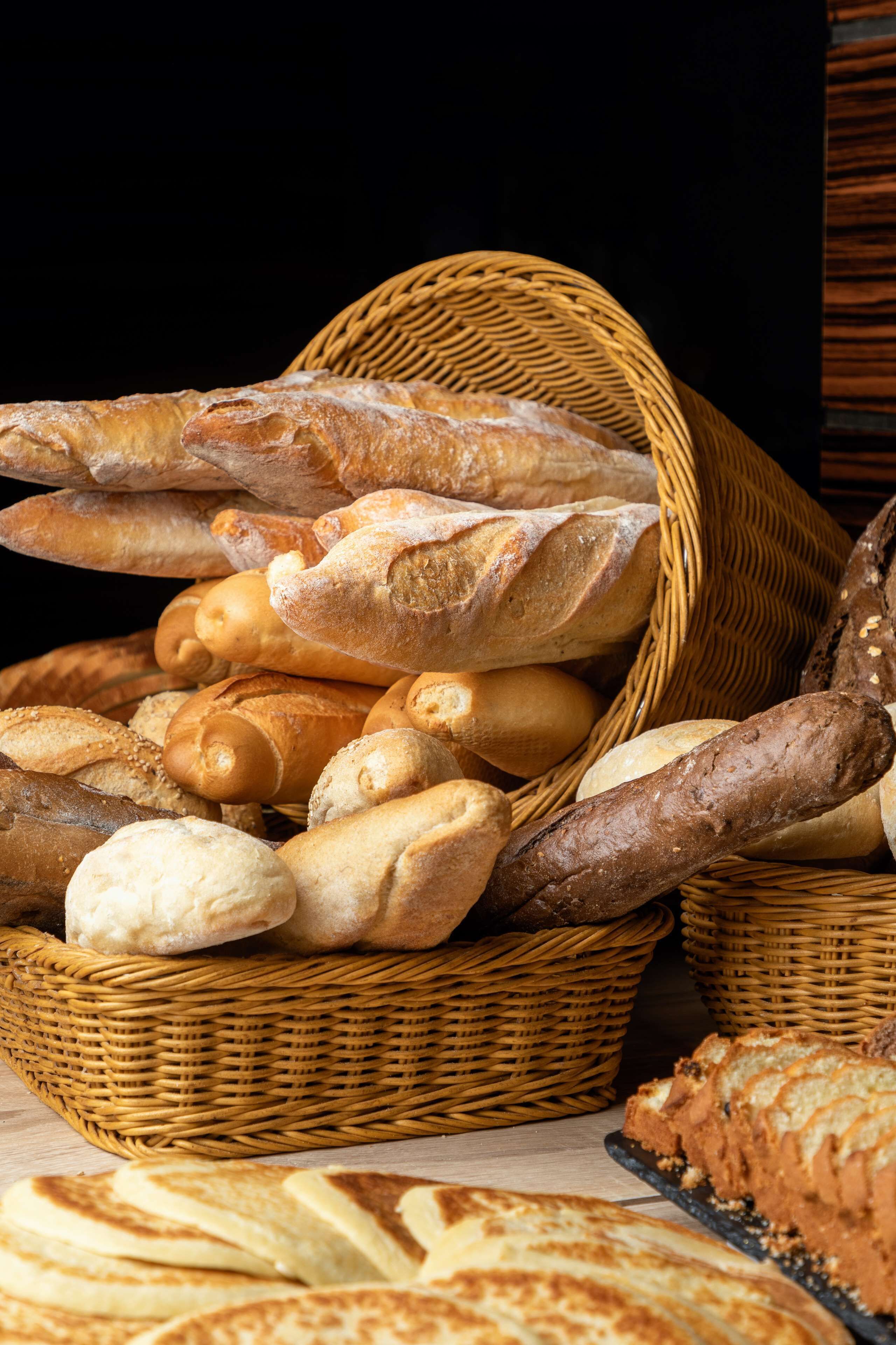 A basket filled with various types of bread.