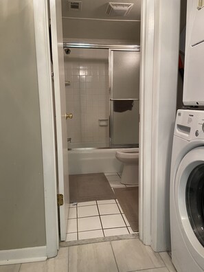 Combined shower/bathtub, towels, soap, toilet paper