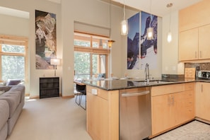 Enjoy cooking in this well-equipped kitchen with a central island, dishwasher, and ample counter space.