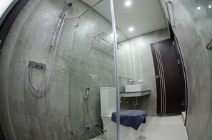 A modern bathroom with a glass shower enclosure, a toilet, and a sink. - The Elegance Pool Villas at KP Beach (Ko Chang)