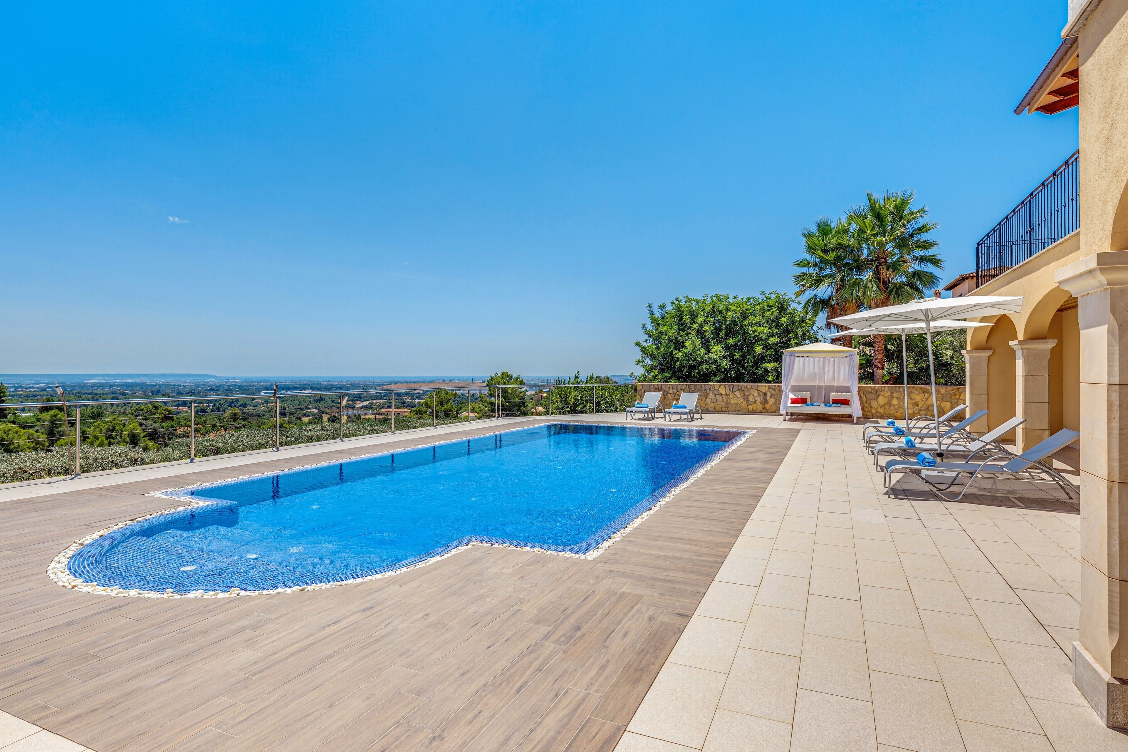 A rooftop swimming pool with a view of the landscape.