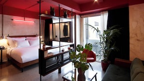A modern hotel room with a bed, a sofa, a coffee table, and a large window. -  Max Brown Hotel Downtown, part of Sircle Collection (Formally known as Dave Red) (Athens)