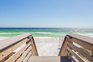 A wooden boardwalk leading to a beach with clear blue water and a sandy shore. - Free Golf Cart, Walk to Beach, Pool Access, Sleeps 10, Bike to Shops & Restaurants! (Santa Rosa Beach)