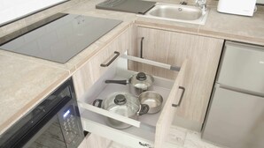 A kitchen with a built-in microwave, a sink, and a toaster.