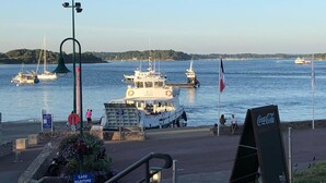 A harbor with boats, a Coca-Cola sign, and a sign indicating a car park. - 100m from the beach, house for 7, seaview (Baden)