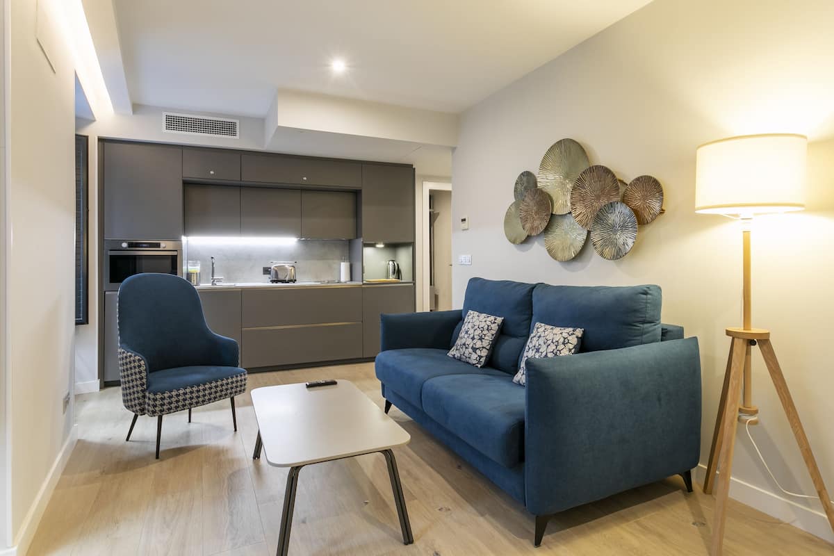 A modern living room with a sofa, armchair, and coffee table.