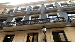 Um edifício com várias varandas, janelas amplas e um poste de luz.