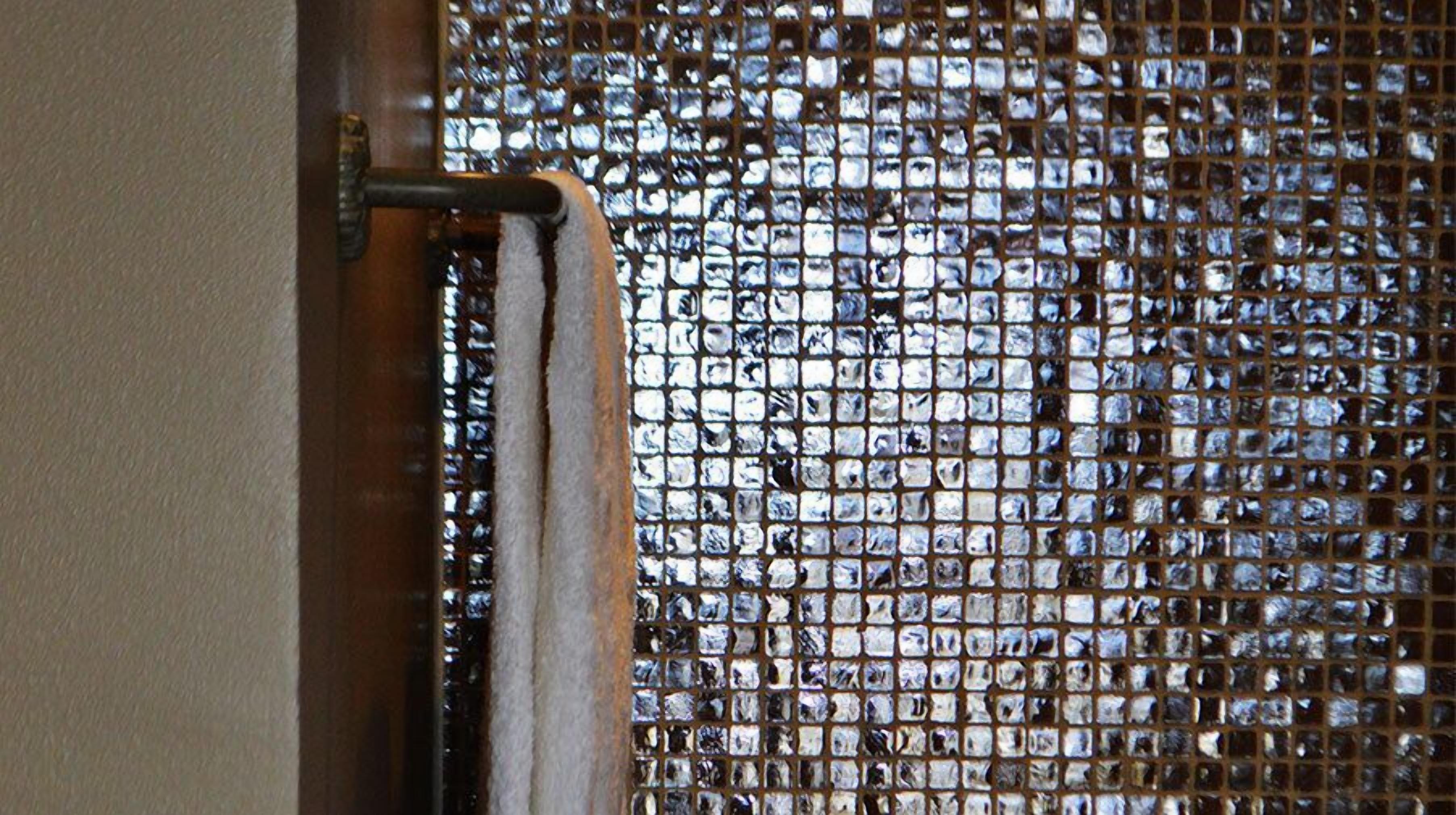 A window with a grid of reflective glass panes.