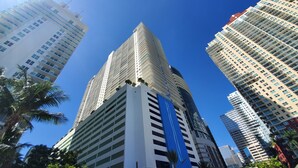 A high-rise building with a modern architectural design, featuring multiple floors and a prominent glass facade.