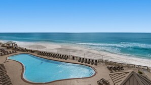 A pool area with a view of the beach and ocean. - Treasure Island 0412 (Panama City Beach)