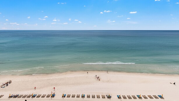 A beach with rows of sun loungers and a clear view of the ocean. - Treasure Island 1009 (Panama City Beach)
