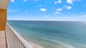 A balcony with a view of the ocean and a clear sky. - Treasure Island 1208 (Panama City Beach)
