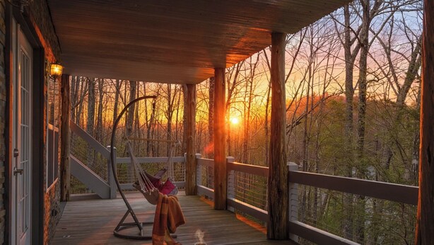 A wooden deck with a hammock, a book, and a cup of coffee. - Lakin' it Easy!*Waterfront*Modern*Kayaks*Resort*WIFI*Pets OK (Deep Gap)