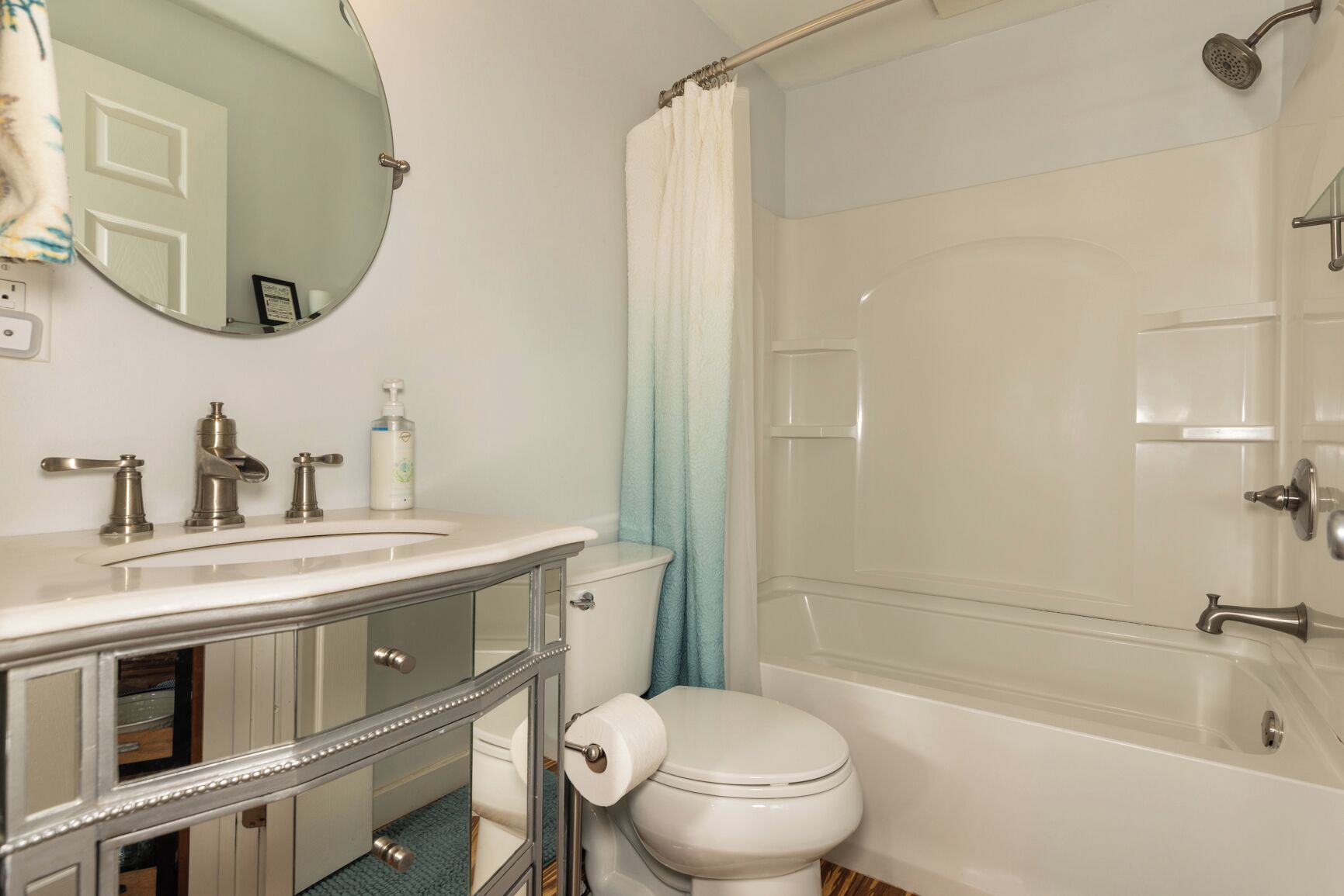 A bathroom with a sink, toilet, and bathtub.