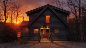 A log cabin with a front porch, a visible door, and a window. - Lakin' it Easy!*Waterfront*Modern*Kayaks*Resort*WIFI*Pets OK (Deep Gap)