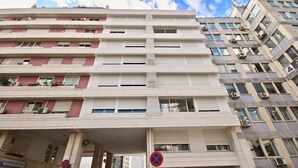 A multi-story building with a flat facade, large windows, and air conditioning units. - Savory Beige Apartment, AC, Wifi !New! (Lisboa)