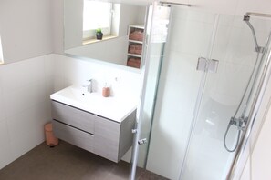 Shower, hair dryer, towels, toilet paper