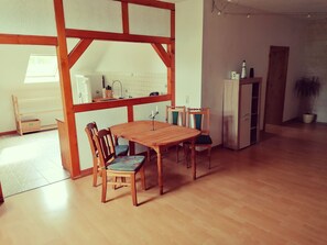 Enjoy meals in this cozy dining area with a wooden table and comfortable seating for four.