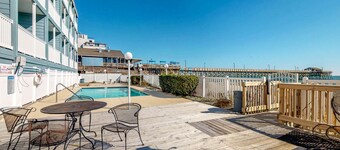 Coastal retreat near the pier w/ a balcony, shared pool, & beach access