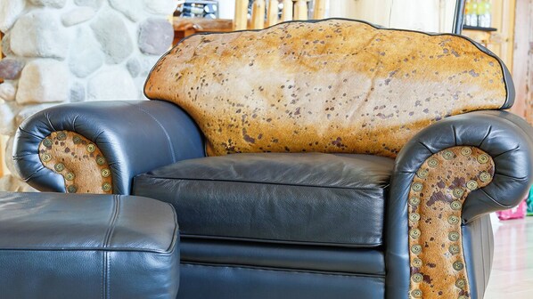 A leather armchair with a patterned cushion and decorative buttons. - Luxury Lakefront Property w/ private beach (Zurich)
