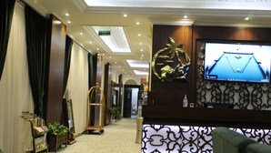 A hotel lobby with a reception desk, a billiards table, and a staircase. - Laylati Al Yarmouk (Riyadh)
