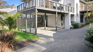 A modern two-story house with a covered patio and a garage.