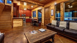 A log cabin interior with a living room, kitchen, and dining area. - Bears 'n Biscuits Cabin, Sleeps 14, Hot tub, Playset, Pool Tbl, 4 brms, 3 baths (Broken Bow)