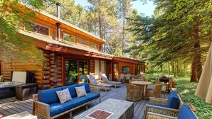 A log cabin with a deck, outdoor seating, and a fireplace. - Abode at the Aspens, hot tub, near Teton Village (Wilson)