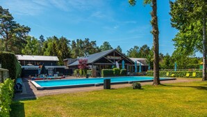 A swimming pool area with a building labeled "De Houtzagerij" in the background. - Modern Chalet Near De Veluwe National Park (Otterlo)