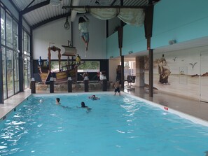 A swimming pool with a ship-themed play structure and a mural of a sailing ship. - Modern Chalet not far From the Biesbosch (Dordrecht)