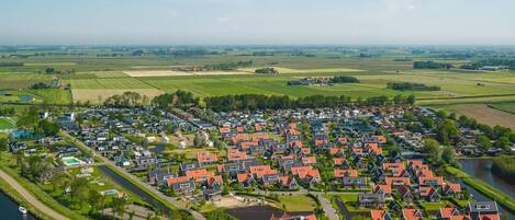 A residential area with houses, a river, and open fields.