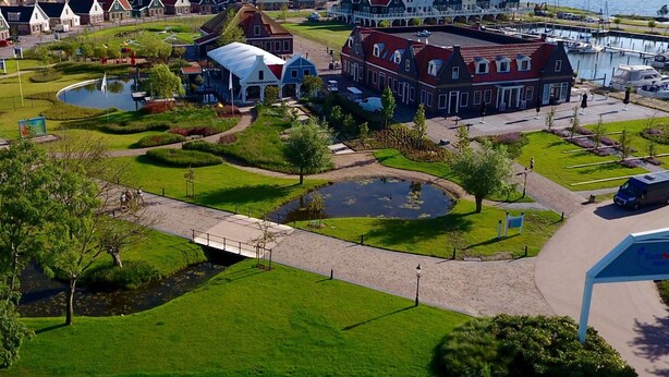 A coastal town with traditional architecture, a marina, and wind turbines. - Holiday Home on the Markermeer Near Amsterdam (Uitdam)