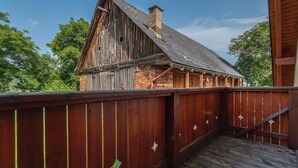 A rustic wooden building with a steeply pitched roof and a brick chimney. - Apartments Sitar (Ribnica na Pohorju)