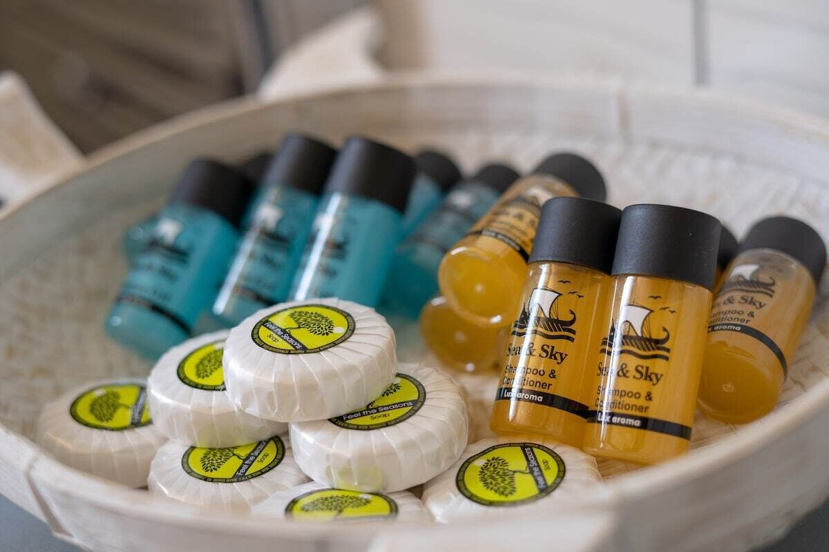 A bowl containing various bottles of hair care products.